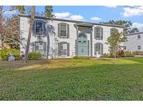 Two-story white brick building with green door, landscaping, and grassy yard at 1330 Snell Isle Ne Blvd # 4, St Petersburg, FL 33704