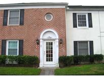 Brick building exterior with a white door entrance, landscaping, and address number at 13760 Orange Sunset Dr # 201, Tampa, FL 33618