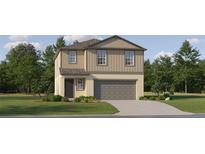 Two-story house with gray siding, a two-car garage, and landscaping at 9366 Runaway Breeze Dr, Land O Lakes, FL 34637