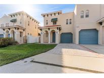 Front view of charming townhome with paved driveway and landscaping at 111 S Melville Ave # 4, Tampa, FL 33606