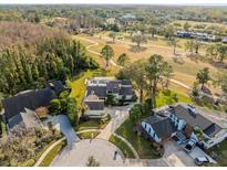 Stunning aerial view of a well-maintained property with a beautiful pool and lush landscaping and golf course at 13032 Whisper Sound Dr, Tampa, FL 33618