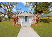 Charming bungalow with a white porch and landscaping at 1318 E Renfro St, Plant City, FL 33563