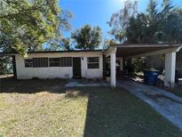 House exterior featuring a carport and a well-maintained lawn at 1357 Terrace Rd, Clearwater, FL 33755