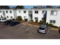 Condo building with parking lot and landscaping at 833 N Keene Rd # W12, Clearwater, FL 33755
