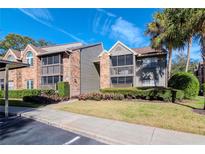 Attractive condo building with landscaping and a gated entrance at 2500 Winding Creek Blvd # I106, Clearwater, FL 33761