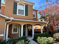 Two-story townhome with green shutters and a covered porch at 6847 Dartmouth Hill St, Riverview, FL 33578