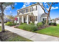 Two-story white house with black shutters, front porch, and landscaped yard at 10023 Brompton Dr, Tampa, FL 33626