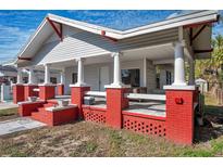 Charming house with a large front porch and red brick accents at 1318 E Louise Ave, Tampa, FL 33603