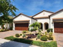 Beautiful two-story home with a landscaped front yard and two-car garage at 17009 Clear Cork Dr, Wimauma, FL 33598