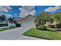 Two story house with a two car garage and lush landscaping at 2429 Silvermoss Dr, Wesley Chapel, FL 33544