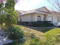 Well-maintained house with a landscaped lawn and a two-car garage at 2547 Stony Brook Ln, Clearwater, FL 33761