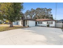 Updated single story home with a large driveway and mature landscaping at 3213 W Grove St, Tampa, FL 33614