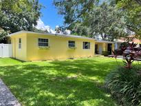 Charming yellow house with well-manicured lawn at 3409 W El Prado Blvd, Tampa, FL 33629