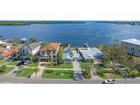 Aerial view of waterfront home with private dock and lush landscaping at 6323 Bayou Grande Ne Blvd, St Petersburg, FL 33702