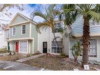 Three-unit townhome building, two-story, with updated paint and landscaping at 13907 Fletchers Mill Dr, Tampa, FL 33613