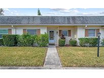 Inviting exterior of a ranch-style home featuring a walkway and landscaping at 1421 Normandy Park Dr # 2, Clearwater, FL 33756