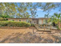 Charming single-story home with a wooden ramp and tidy landscaping at 215 Druid Hills Rd, Temple Terrace, FL 33617