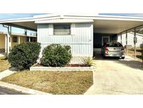 Mobile home with carport and landscaped yard at 9790 66Th N St # 33, Pinellas Park, FL 33782
