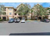 Tan multi-unit building with ample parking and landscaping at 1429 Villa Capri Cir # 306, Odessa, FL 33556