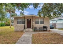Tan block house with brown door, small front yard, and driveway at 652 13Th S Ave, St Petersburg, FL 33701