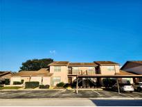 Two-story condo building with parking and landscaped grounds at 1040 Bowsprit Ln # 1306, Holiday, FL 34691