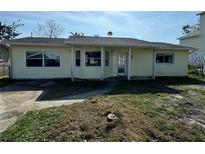 Cute yellow house with a front yard at 225 174Th E Ave, Redington Shores, FL 33708