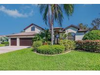 Charming two-story home with lush landscaping and a well-manicured lawn at 335 Palmdale Dr, Oldsmar, FL 34677