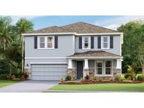 Two-story house with gray siding, stone accents, and a two-car garage at 3828 Turning Tides Ter, Bradenton, FL 34208