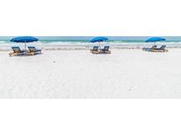Beachfront property with lounge chairs and umbrellas at 16750 Gulf Blvd # 413, North Redington Beach, FL 33708