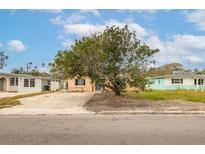 Ranch-style house with a large front yard and mature tree at 4000 Huntington Ne St, St Petersburg, FL 33703