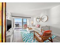 Bright living room with water views, comfy seating, and stylish decor at 6265 Sun Blvd # 101, St Petersburg, FL 33715