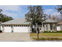 Attractive single-story home with three-car garage and manicured lawn at 8537 Orsi Ct, Trinity, FL 34655