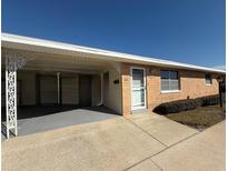 Brick ranch-style home with carport and mature landscaping at 12400 Park Blvd # 321, Seminole, FL 33772