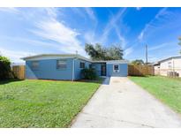 Newly painted light blue home with a spacious yard and driveway at 2009 Windsor Way, Tampa, FL 33619