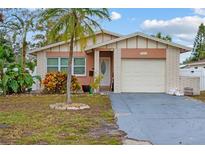 Brick ranch home with attached garage and landscaped yard at 651 Southwest N Blvd, St Petersburg, FL 33703