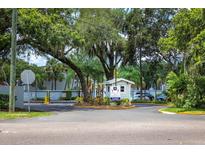 Gated community entrance with lush landscaping and security booth at 7124 Waterside Dr # 7124, Tampa, FL 33617