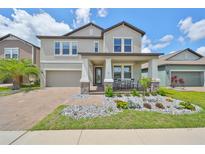 Two-story house with stone accents and a landscaped front yard at 9608 Ivory Dr, Ruskin, FL 33573