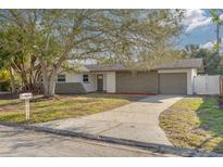 Updated single story home with gray stone facade and landscaped yard at 2215 Cedar Dr, Dunedin, FL 34698