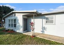 Newly renovated home with gray accents and a landscaped yard at 4918 Cresthill Dr, Tampa, FL 33615