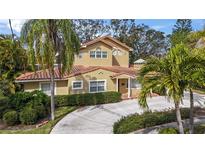 Attractive two-story home with tile roof and landscaped yard at 660 Geneva Pl, Tampa, FL 33606