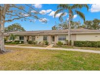 Tan brick condo with a small front yard and walkway at 1084 Dunrobin Dr # D, Palm Harbor, FL 34684