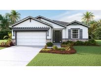 One-story home with white exterior, gray accents, and landscaping at 18220 Beach Ranch Ter, Lakewood Ranch, FL 34211