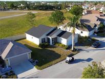 Aerial view of a single-Gathering home with a golf course nearby at 24165 Buckingham Way, Punta Gorda, FL 33980