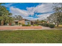 Brick ranch home with landscaped yard and walkway at 3201 Belmore Rd, Tampa, FL 33618