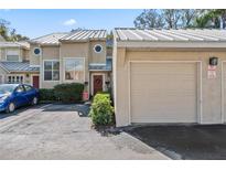 Front view of townhouse with attached garage and landscaping at 3406 Waterbridge Dr, Tampa, FL 33618