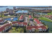 Aerial view of a waterfront community with lush landscaping and multiple buildings at 6085 Bahia Del Mar Blvd # 105, St Petersburg, FL 33715