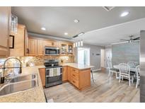 Updated kitchen with stainless steel appliances and view of dining area at 717 Carolina Ave, Tarpon Springs, FL 34689