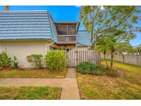 Back exterior view of condo, showing private patio and wooden fence at 14525 Catalina Cir, Seminole, FL 33776