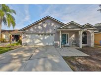 One-story house with a two-car garage and landscaped yard at 305 Crayford Pl, Valrico, FL 33594