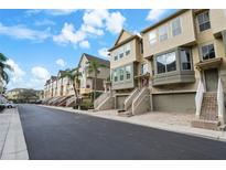 Row of charming townhouses with attached garages and lush landscaping at 4334 Spinnaker Cove Ln, Tampa, FL 33615